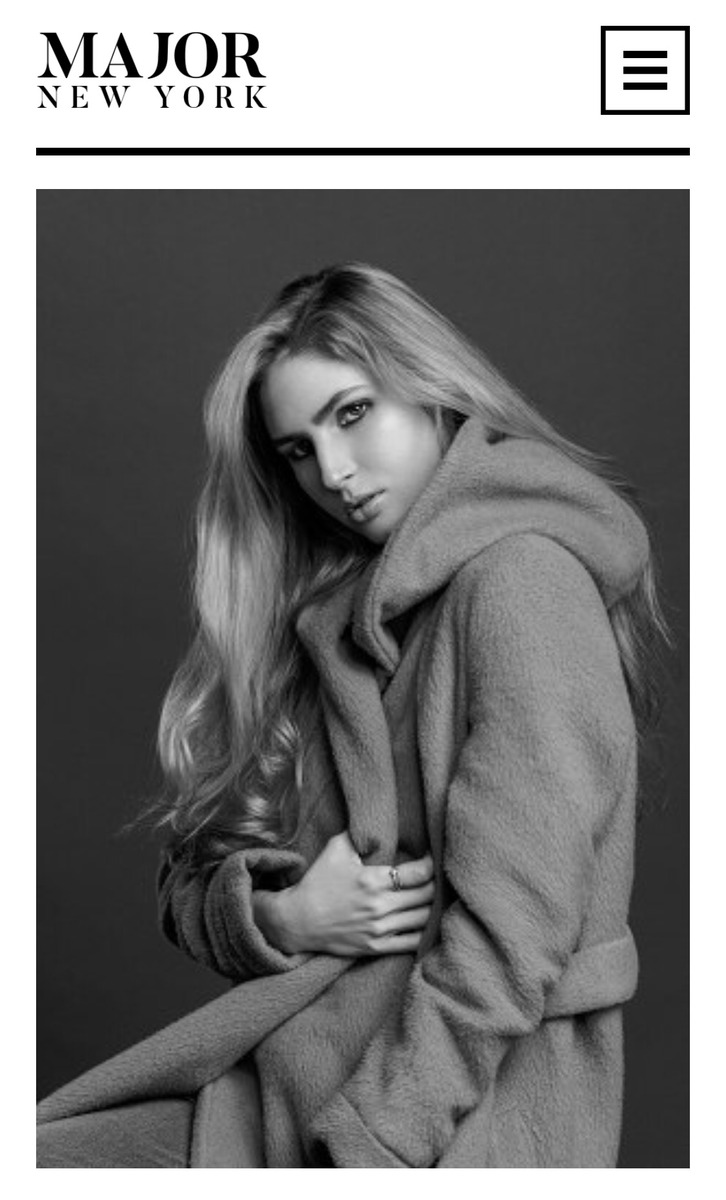 Ali Kirsch in a black-and-white seated fashion portrait