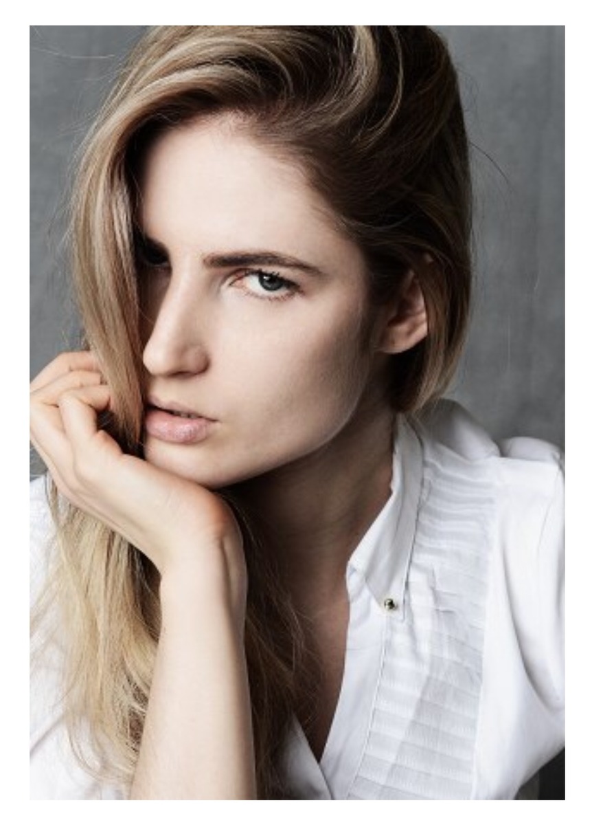 Ali Kirsch in a close beauty portrait wearing a white shirt