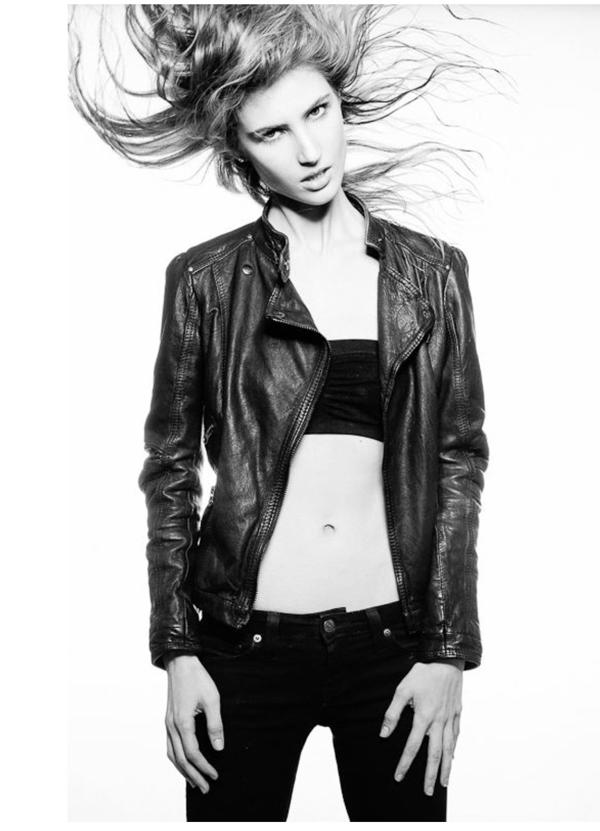 Ali Kirsch in a black-and-white full-length leather jacket portrait