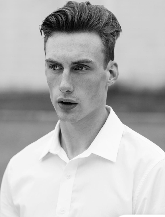 Austen in a black-and-white close portrait wearing a white shirt