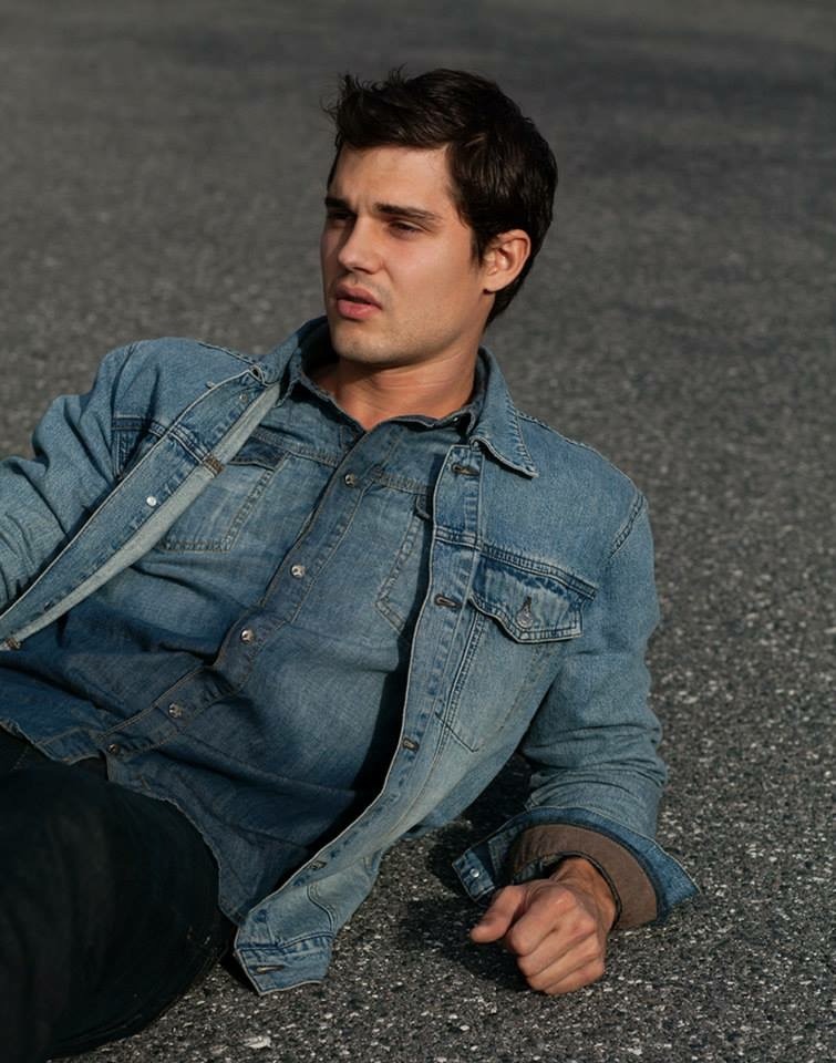 Jason reclining in a blue denim fashion portrait