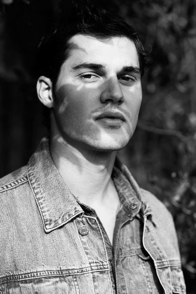 Jason in a black-and-white denim jacket portrait