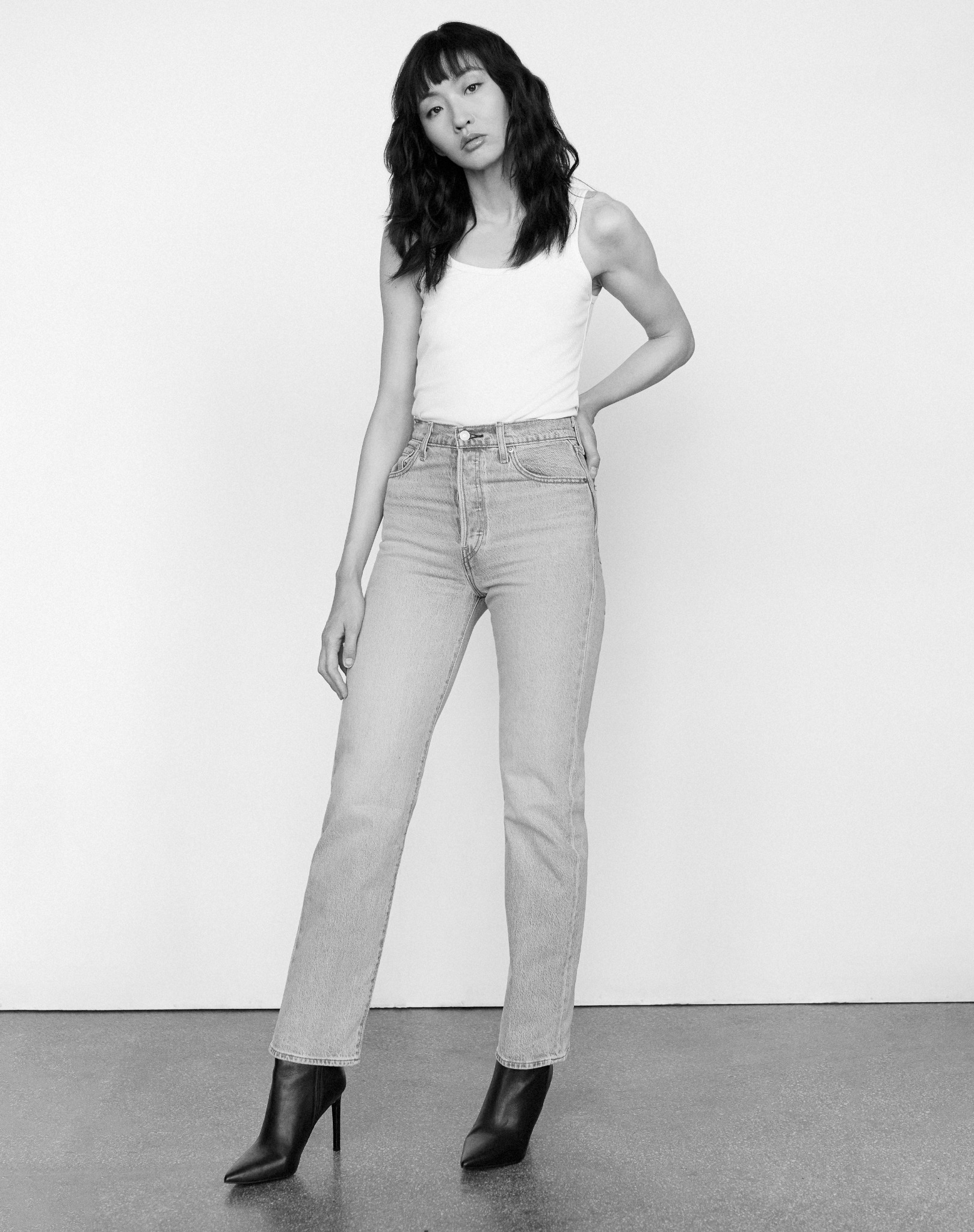 Tian standing in a black-and-white denim editorial
