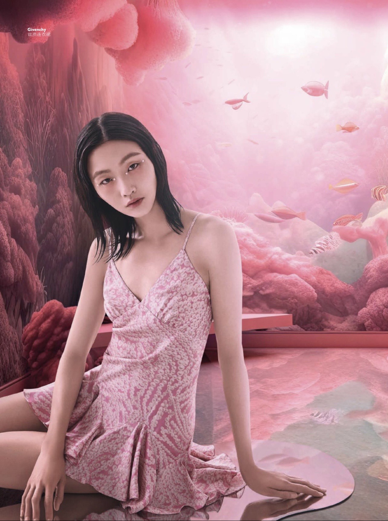 Tian seated in a pink surreal landscape