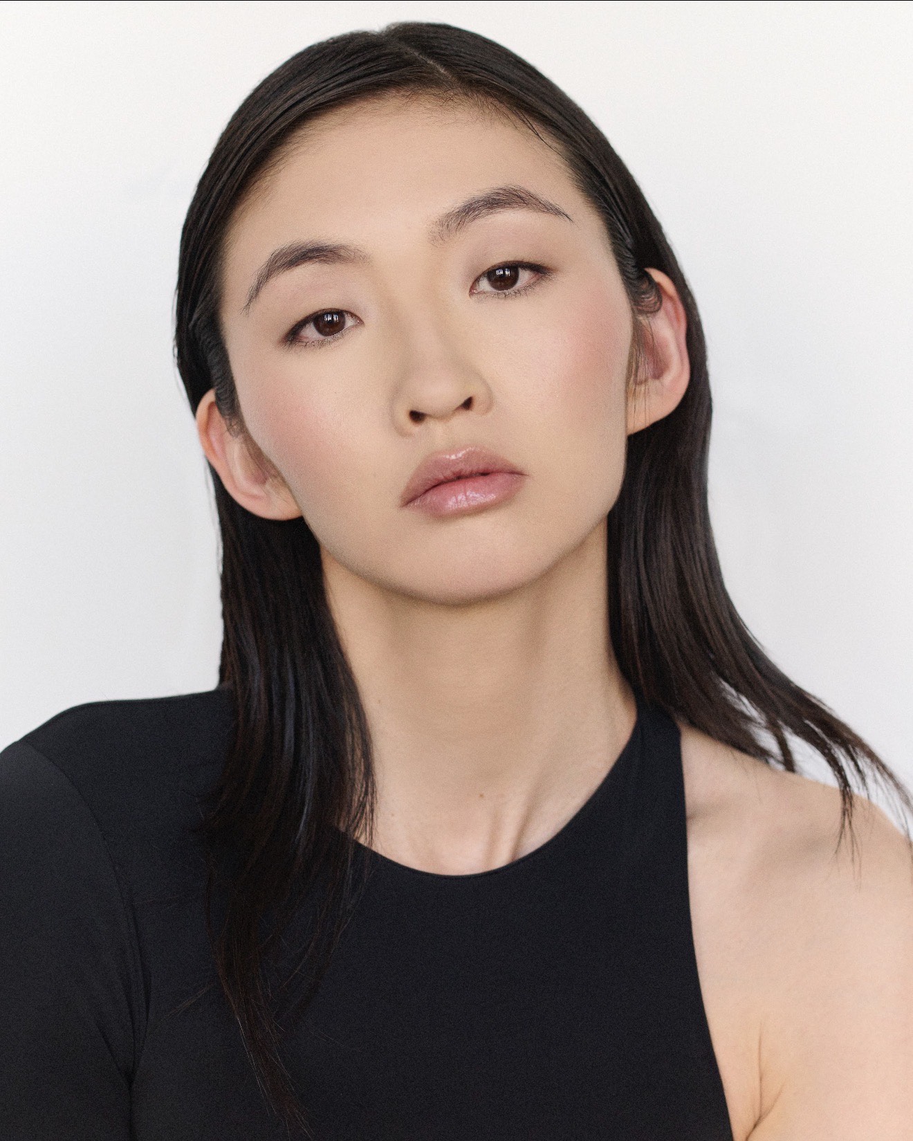 Tian in a clean beauty portrait wearing a black top